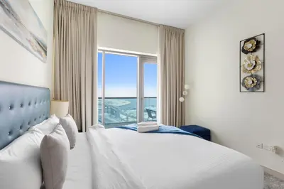 a bedroom with a bed and a large window at Spacious 1 bedroom in Business Bay - Close to Downtown in Dubai