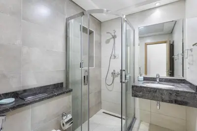 a bathroom with a glass shower and a sink at Spacious 1 bedroom in Business Bay - Close to Downtown in Dubai