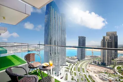 a balcony with a view of a city at LUX The Dubai Creek View Suite in Dubai