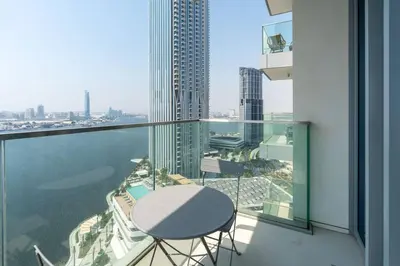 a table and chairs on the balcony of a building at 2bdr Emaar The Grand - Sea View - Creek Harboor in Dubai