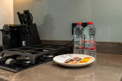 two bottles of water on a counter next to a stove at Studio in heart of Dubai - 15 Northside - Business Bay in Dubai
