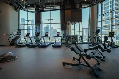 a gym with treadmills and exercise equipment in a building at Studio in heart of Dubai - 15 Northside - Business Bay in Dubai