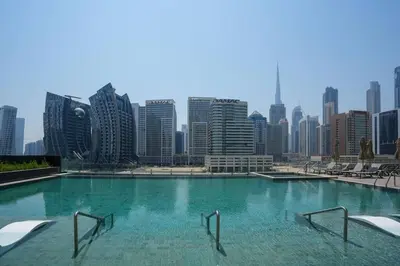 a large swimming pool with a city skyline in the background at Studio in heart of Dubai - 15 Northside - Business Bay in Dubai