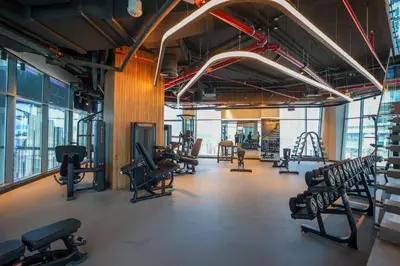 a gym with treadmills and chairs in a room at Studio in heart of Dubai - 15 Northside - Business Bay in Dubai
