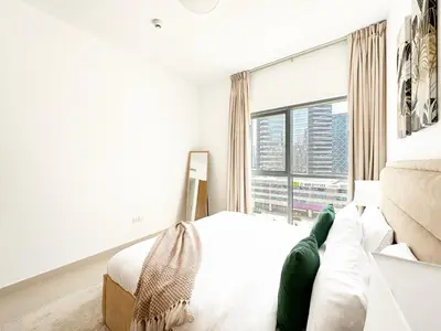 a bedroom with a bed and a large window at Trophy - Downtown Skyline Sanctuary Suite in Dubai