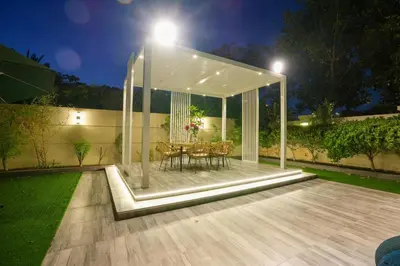 a white gazebo with a table and chairs at Private villa in Dubai with swimming pool and huge garden in Dubai
