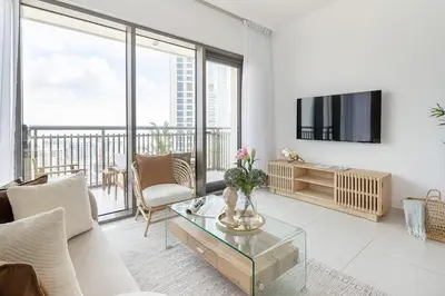 a living room with a couch and a tv at Frank Porter - Creekside 18 in Dubai