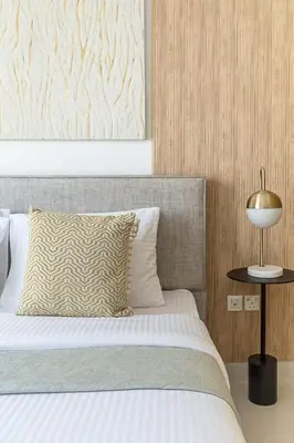 a bedroom with a bed with a pillow and a table at Frank Porter - Creekside 18 in Dubai