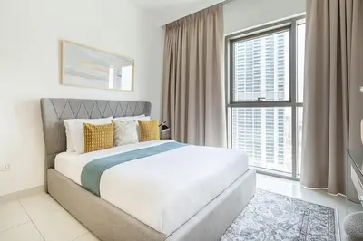 a bedroom with a large bed and a large window at Frank Porter - Creekside 18 in Dubai