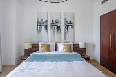 a bedroom with a large bed with two lamps at Frank Porter - Beauport in Dubai