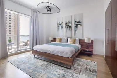 a bedroom with a large bed and a large window at Frank Porter - Beauport in Dubai
