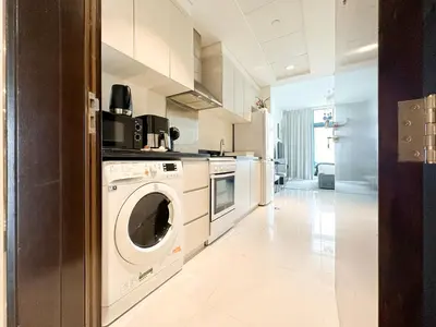 a kitchen with a washer and dryer at Trophy - Urban Escape Suite in Dubai