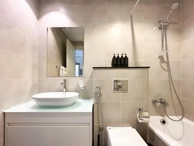 a bathroom with a sink and a shower at Trophy - Urban Escape Suite in Dubai