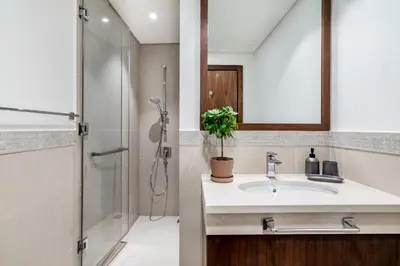 a bathroom with a sink and a shower at The Smart Concierge - Burjvista in Dubai