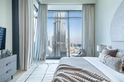 a bedroom with a large window with a view of a city at The Smart Concierge - Burjvista in Dubai