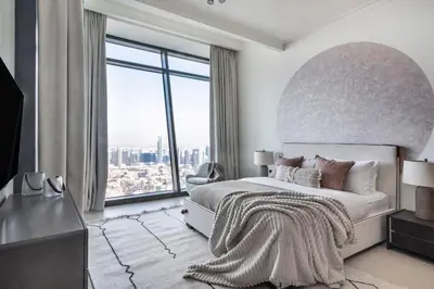 a bedroom with a large bed with a large window at The Smart Concierge - Burjvista in Dubai