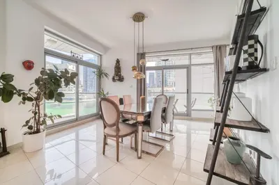 a dining room with a table and chairs and windows at Fairfield Tower, Park Island, Dubai Marina - Mint Stay in Dubai