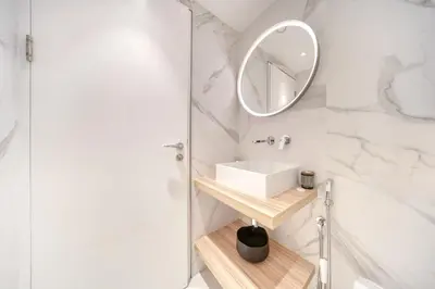 a white bathroom with a sink and a mirror at Fairfield Tower, Park Island, Dubai Marina - Mint Stay in Dubai