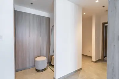 a room with a closet with a stool and a wall at Luxurious 3BR Apartment with Panoramic Marina View in Dubai