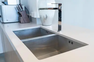 a kitchen sink with a faucet on a counter at Luxurious 3BR Apartment with Panoramic Marina View in Dubai