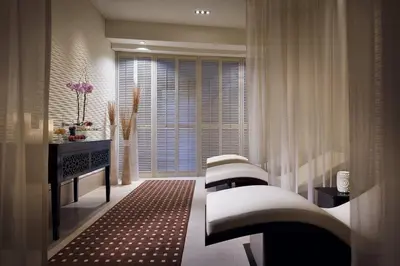 a living room with two beds and a window at Emaar Dubai Mall Residences - formerly Address Dubai Mall Residences - Burj Khalifa View in Dubai