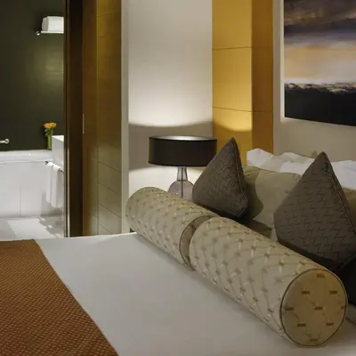 a bedroom with a bed with pillows and a lamp at Emaar Dubai Mall Residences - formerly Address Dubai Mall Residences - Burj Khalifa View in Dubai