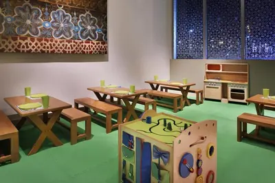 a dining room with wooden tables and wooden benches at Emaar Dubai Mall Residences - formerly Address Dubai Mall Residences - Burj Khalifa View in Dubai