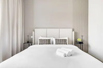 a bedroom with a white bed with towels on it at Luxurious 3BR Villa Amaranta in Dubai