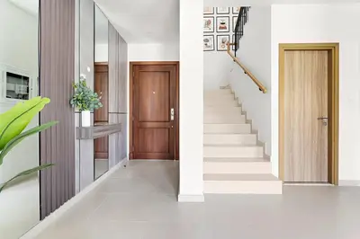 a hallway with a staircase with a wooden door at Luxurious 3BR Villa Amaranta in Dubai