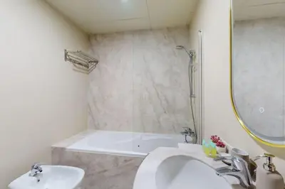 a bathroom with a sink and a bath tub at V3 Tower - Elegant One Bedroom in Dubai
