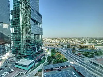 an aerial view of a city with a tall building at V3 Tower - Elegant One Bedroom in Dubai