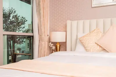 a bedroom with a white bed and a window at Elite Royal Apartment - Full Burj Khalifa & Fountain View - Highness in Dubai