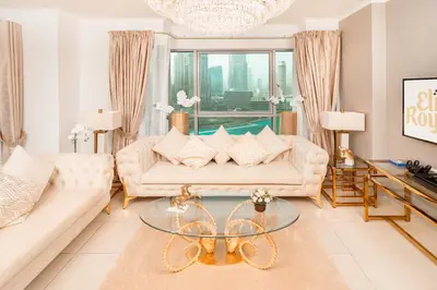 a living room with a couch and a glass table at Elite Royal Apartment - Full Burj Khalifa & Fountain View - Highness in Dubai