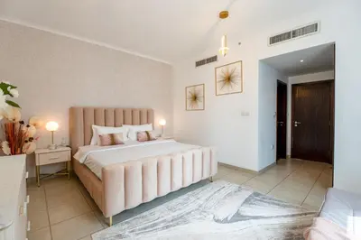 a large bedroom with a large bed and a table at INA Homes-Tower 5 Perfect Burj Khalifa and Fountain Views in Dubai