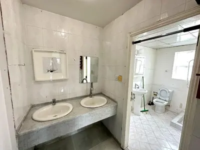 a bathroom with two sinks and a toilet at Nice Rooms for Rent in Compound Housing near Burj Alarab Dubai Villa 125 in Dubai