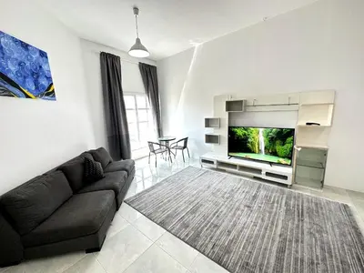 a living room with a couch and a flat screen tv at Nice Rooms for Rent in Compound Housing near Burj Alarab Dubai Villa 125 in Dubai
