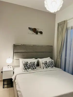 a bedroom with a large bed and a chandelier at INA Homes-BLVD Central 2BHK Apartment near Burj Khalifa in Dubai