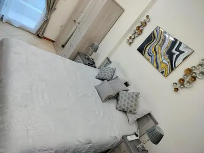 a bedroom with a large bed with pillows at Diamond 2 Tower Marina Apartment in Dubai