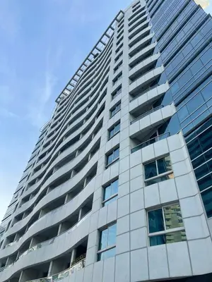 a tall building with many windows on the side of it at Diamond 2 Tower Marina Apartment in Dubai