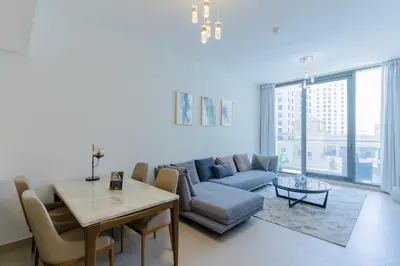 a living room with a couch and a table at Sleek 1 Bedroom with Views of Dubai Marina in Dubai