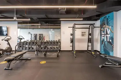 a gym with lots of weights and machines at Sleek 1 Bedroom with Views of Dubai Marina in Dubai