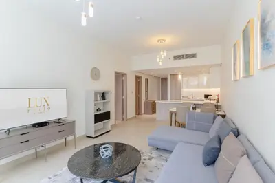 a living room with a couch and a table at Sleek 1 Bedroom with Views of Dubai Marina in Dubai