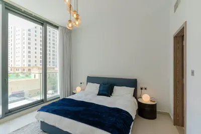 a bedroom with a bed and a large window at Sleek 1 Bedroom with Views of Dubai Marina in Dubai