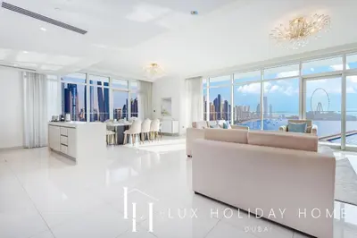 a living room with a couch and a table at LUX The Ultimate Palm Sea Skyline Penthouse in Dubai