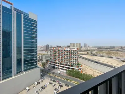 a view of a city from a balcony of a building at Silkhaus modern 1BDR in Belgravia Heights with pool & gym in Dubai