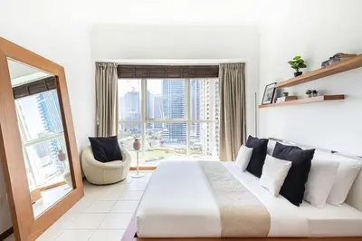a bedroom with a large bed and a large window at Frank Porter - MAG214 in Dubai
