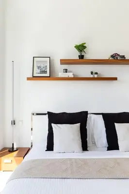 a bed with black and white pillows in a bedroom at Frank Porter - MAG214 in Dubai
