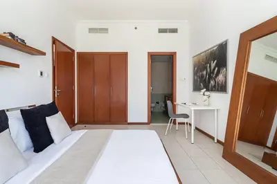 a bedroom with a bed and a desk and a table at Frank Porter - MAG214 in Dubai