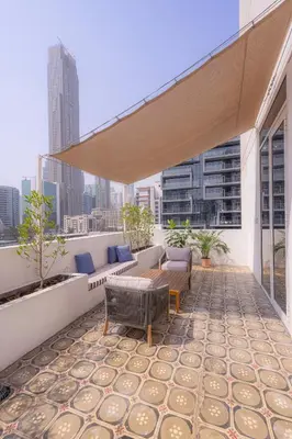 a rooftop patio with furniture and a view of the city at Shada Hotel Dubai - فندق شدا دبي in Dubai