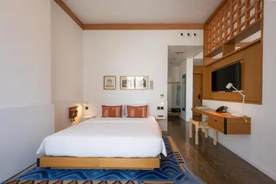 a bedroom with a bed and a desk and a tv at Shada Hotel Dubai - فندق شدا دبي in Dubai